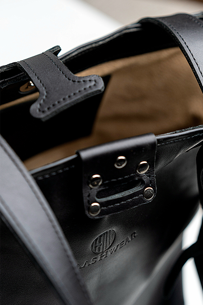 Close up of a handbag and accessories on it.