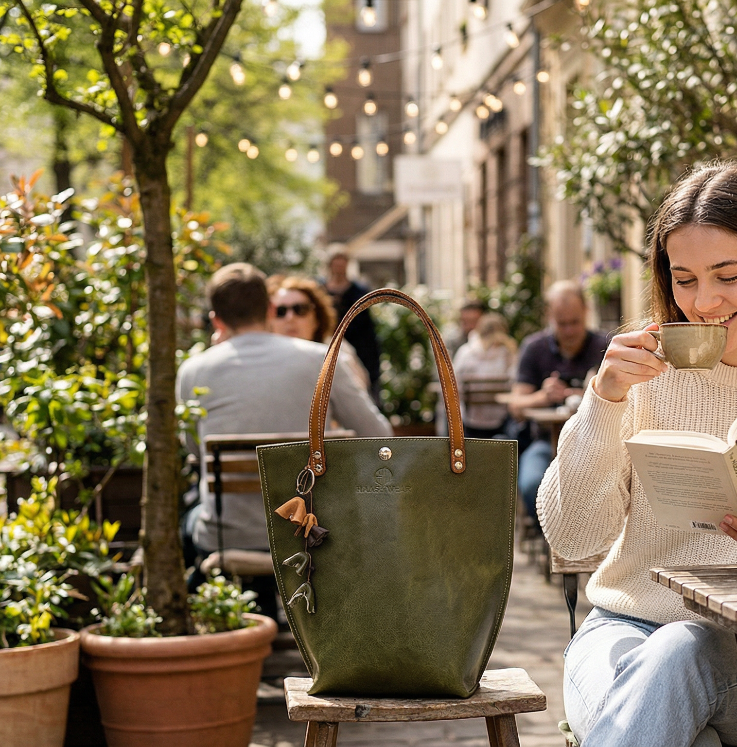 Woman reading a book next to a green handbag