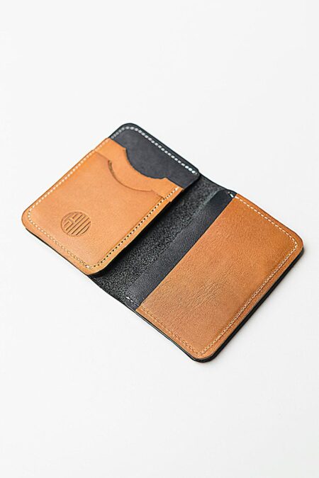 Men's wallet open showing a black and beige interior